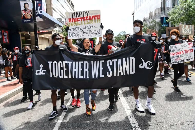 Natasha Cloud, center, was a leader of protests last summer by the WNBA's Washington Mystics and NBA's Washington Wizards against racism and police brutality.