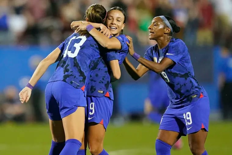 Alex Morgan (left) celebrates with Mallory Swanson (center) and Crystal Dunn (right) after Morgan's goal against Brazil.