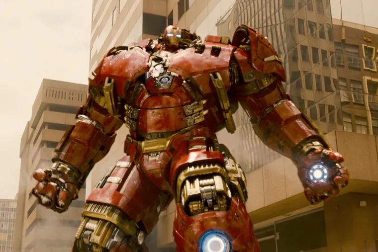 Joss Whedon directs the gang in a story about a Tony Stark (seen here in his "Hulk buster" Iron Man armor) A.I. program gone awry, threatening humanity.
