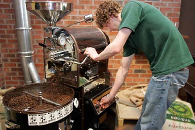 Benson Endicott tends the chromed roaster, filled with a Colombian blend, at Burlap & Bean.