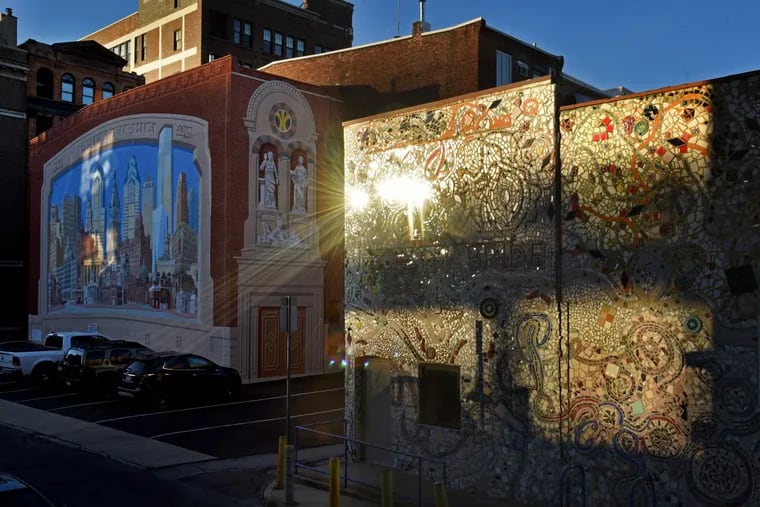 The setting sun reflects off Isaiah Zagar’s mosaics on the Painted Bride Wednesday. Executive Director Laurel Raczka says the sale of the building on Vine Street in Old City will help position the arts group for a vital future.