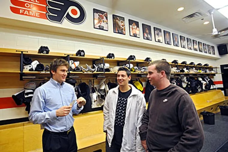 In the Flyers locker room, Flyers rookie James van Reimsdyk (left) chats with his buddies from high school, Paul Passariello (center) and Pat Keenan (right), both are juniors at Villanova and regulars at home games.