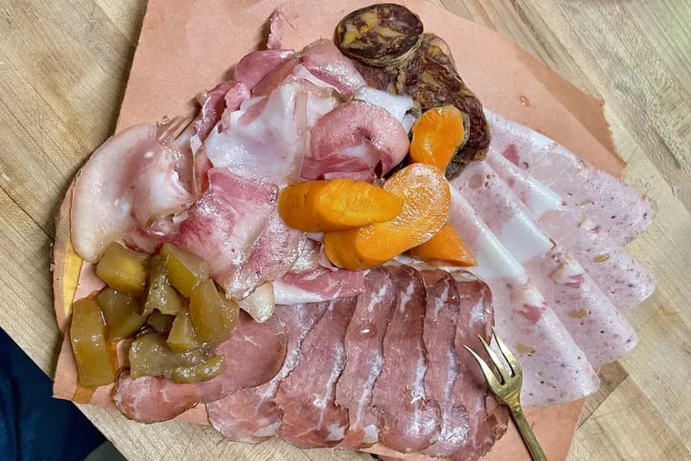 A charcuterie meat board sold as an add-on to the four-course trattoria meal at Heavy Metal Sausage Co. includes (clockwise from right) Pennsylvania-spiced mortadella, bresaola, porchetta di testa, and beef salami.