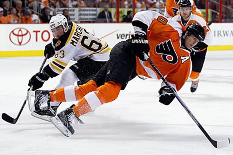 Flyers defenseman Chris Pronger gets tripped by the Bruins' Brad Marchand during the third period. (Yong Kim/Staff Photographer)