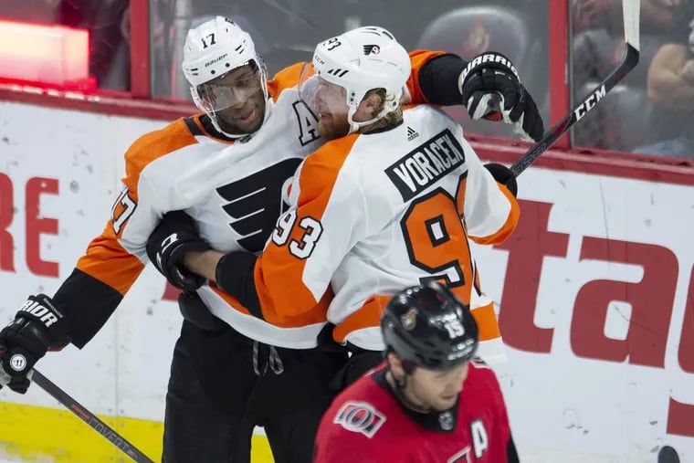 Ottawa Senators left winger Zack Smith skates away as Flyers right winger Jake Voracek, right rear, celebrates his goal with Wayne Simmonds during the first period Wednesday.