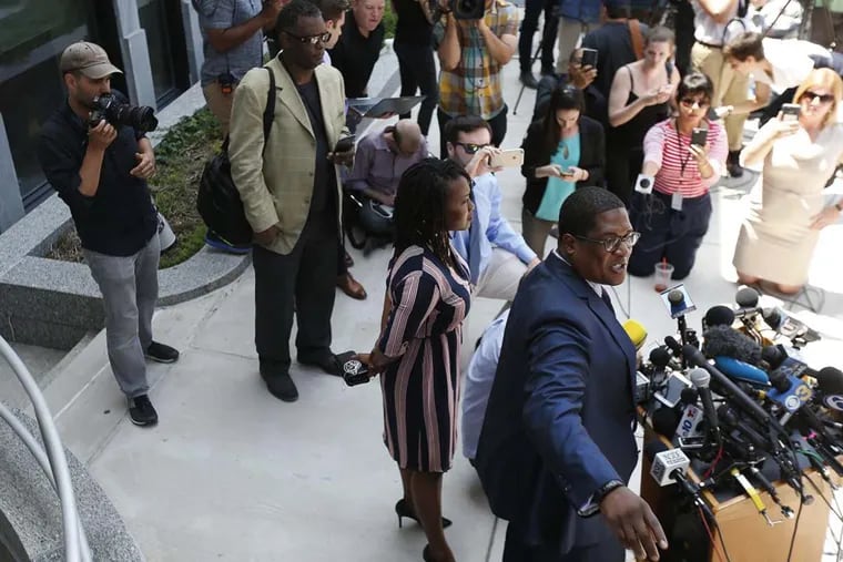 Andrew Wyatt, right, the spokesman for Bill Cosby, speaks to reporters outside the Montgomery County Courthouse as jurors deliberated in Cosby’s trial.