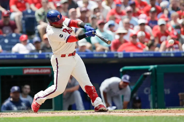 The Phillies' Jean Segura hits a first-inning RBI single against the Padres.
