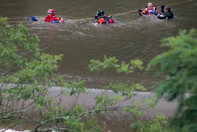Philadelphia police marine unit officers inside Pennypack creek as they search for a missing youth. Philadelphia police marine unit search the Pennypack Creek in Pennypack Park in the northeast section of the city on Monday, July 1, 2013. Early Monday afternoon police and fire responded to reports of a young boy in the river.