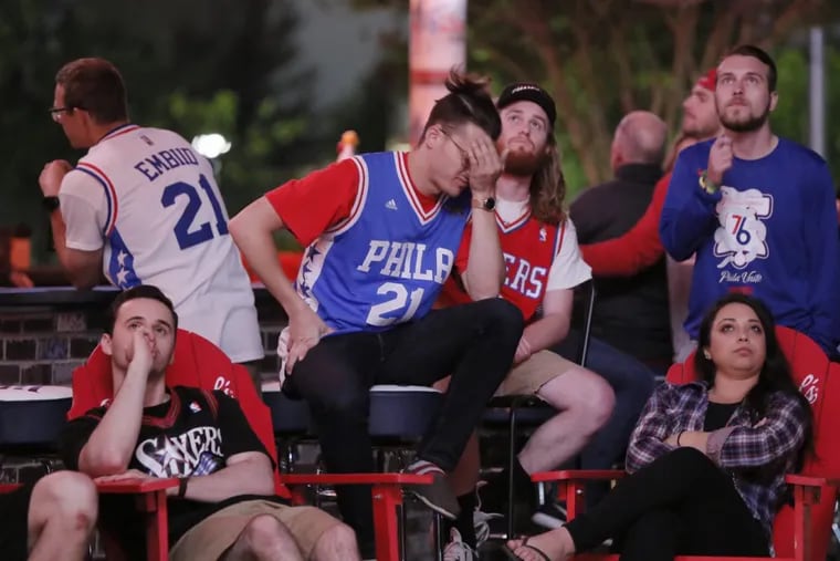Sixers fans at Xfinity Live Philadelphia react as they watch the Sixers play the Celtics in game 5 of the playoffs on May 9, 2018.