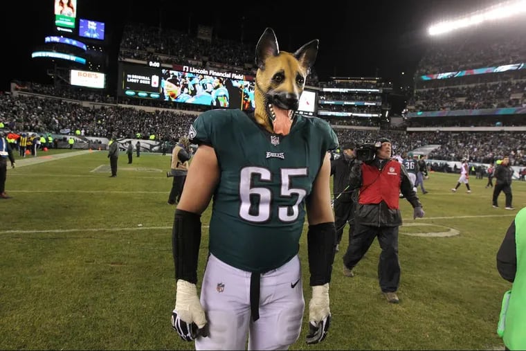 Eagle offensive lineman Lane Johnson dons a dog mask and walks off the field after the Eagles defeated the Atlanta Falcons 15-10 to advance to the NFC Championship game.