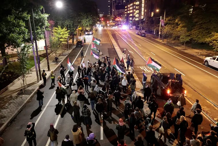 Pro-Palestinian activists march north on 38th Street in University City on Friday.