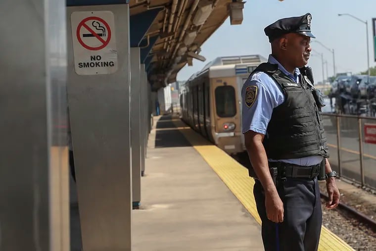SEPTA police officer Kevin Newton on the platform of Spring Garden station as an eastbound El train departs in Philadelphia.