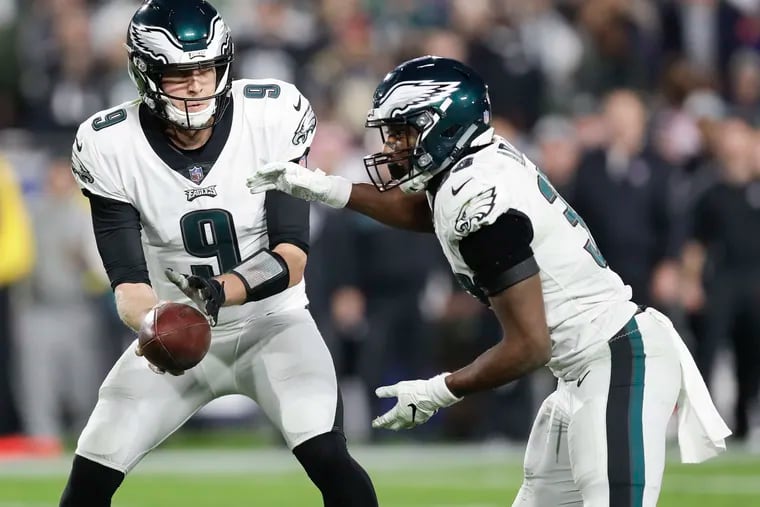 Eagles quarterback Nick Foles hands off the football to running back Josh Adams against the Los Angeles Rams on Sunday, December 16, 2018 in Los Angeles.  YONG KIM / Staff Photographer