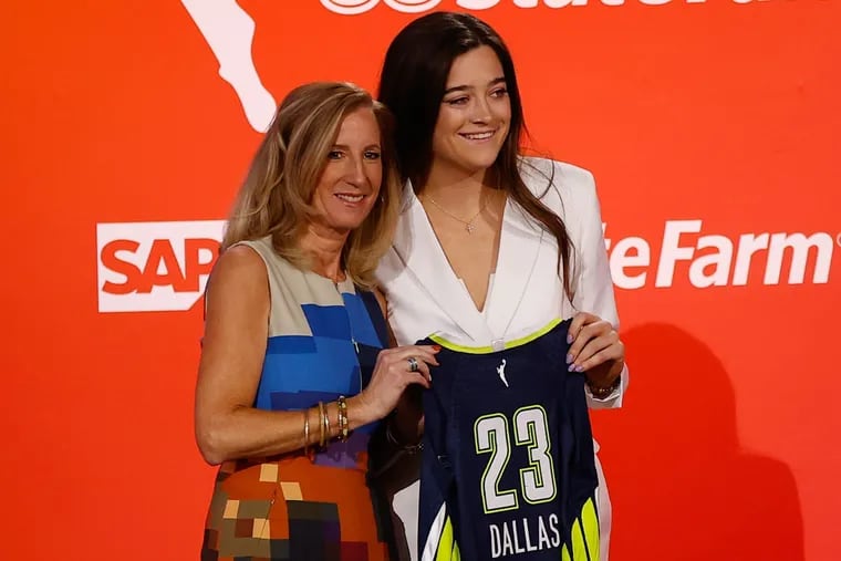 Former Villanova star Maddy Siegrist poses with her Dallas Wings jersey and WNBA Commissioner Cathy Engelbert.