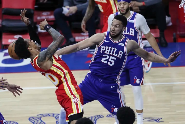 Ben Simmons knocks the ball away from the Hawks' John Collins during Friday's Sixers win.