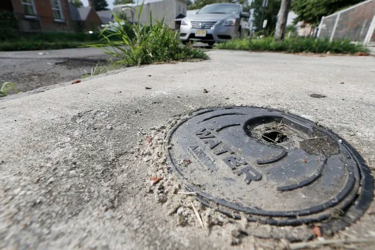 A water meter cover in front of 1918 Filmore St. in Camden, N.J. on Aug. 8, 2018. ELIZABETH ROBERTSON / Staff Photographer