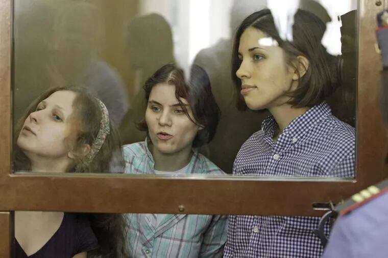 Yekaterina Samutsevich (left), Maria Alekhina and Nadezhda Tolokonnikovaof Pussy Riot sit behind bars at a courtroom in Moscow Monday.

ASSOCIATED PRESS