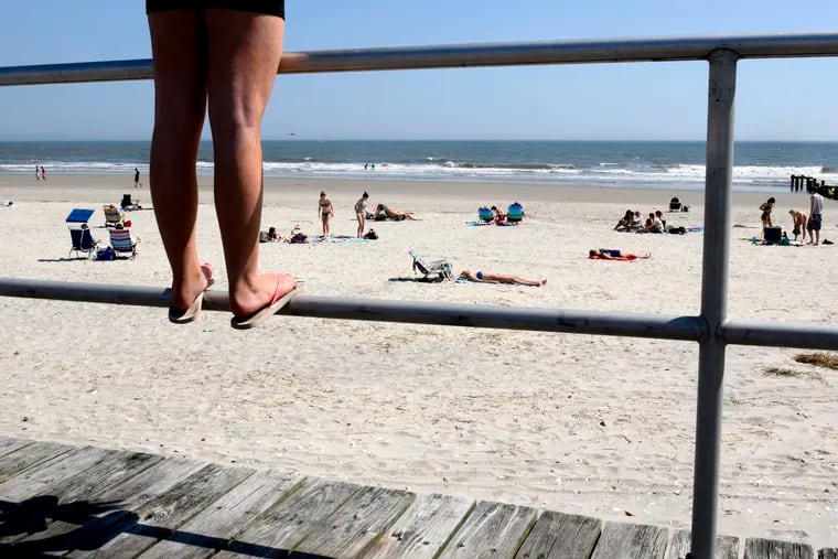 Twelve year-old Madison Hollingsworth stands on the boardwalk railing in Ocean City, as she visits the Jersey shore from Clementon, with her mother and mom-mom April 10, 2013 TOM GRALISH / Staff Photographer