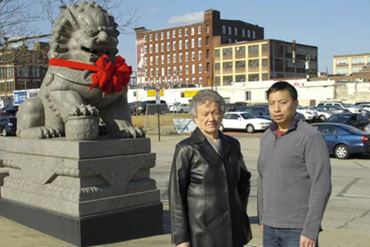 John Chin and Cecilia Moy Yep, officers of the Phila. Chinatown Development Corp., at the vacant lot on 10th and Vine where a new community center, apartment building and retail project has been proposed. (Alex Remnick / Staff Photographer)