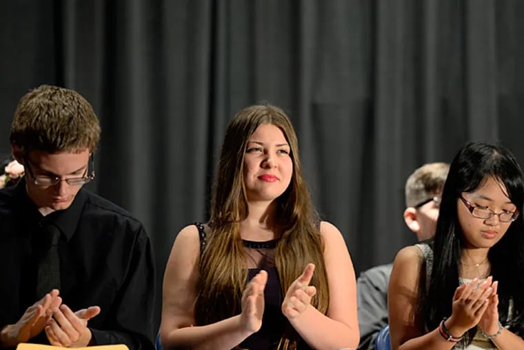 Anastasia Torres (center) during Senior Awards Night ceremonies at Lindenwold High School June 10, 2015, where she was recognized with a number of achievement awards and scholarships. ( TOM GRALISH / Staff Photographer )