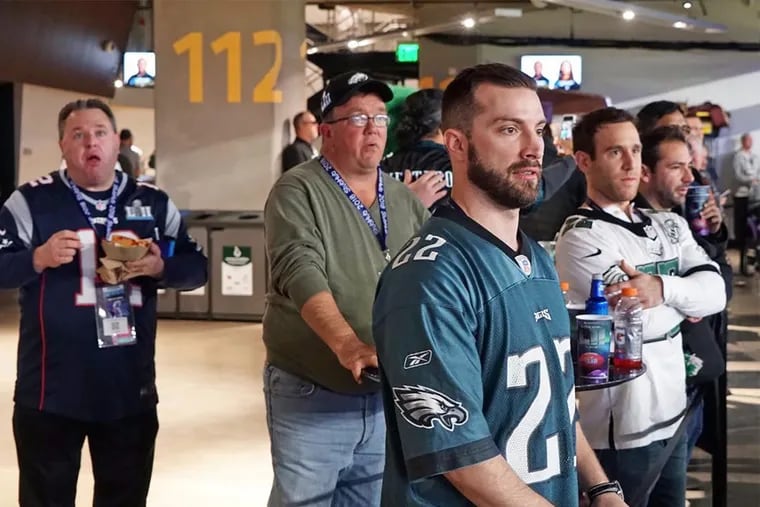 Tony Romano (center, in green pullover) watching the Philadelphia Eagles play the New England Patriots in Super Bowl LII at U.S. Bank Stadium in Minneapolis.