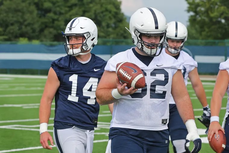 Penn State football quarterback Sean Clifford (14) with center Michal Menet (62) during the team's second practice of the preseason on Aug. 3, 2019. CRAIG HOUTZ / For the Inquirer