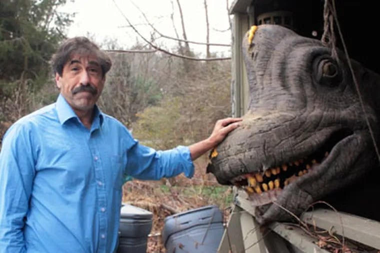 Art Carey writes about "Dino" Don Lessem, a lifelong dinosaur fanatic whose home in Media is filled with dinosaur replicas and bones, including casts of the dinosaurs used in Jurassic Park. He's the driving force behind Giant Mysterious Dinosaurs, the new dinosaur exhibit at the Franklin Institute.IN THIS PHOTO, Dino" Don Lessem with a Brachiosaurus head from the Jurrasic Park movie which is stored in his gararage. (Ed Hille / Staff Photographer) dm1dinoxx  Dec 10, 2011 126148