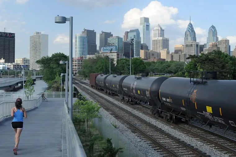 Slow-moving, mile-long crude oil trains are seen from the South Street Bridge, along the Schuylkill Banks Boardwalk.