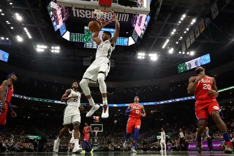 Milwaukee Bucks' Giannis Antetokounmpo dunks during the first half of an NBA basketball game against the Sixers on Saturday.