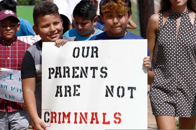 Children of mainly Latino immigrant parents hold signs in support of them and those individuals picked up during an immigration raid at a food processing plant, during a protest march to the Madison County Courthouse in Canton, Miss., following a Spanish Mass at Sacred Heart Catholic Church in Canton.  Trump administration rules that could deny green cards to immigrants if they use Medicaid, food stamps, housing vouchers or other forms of public assistance are going into effect.