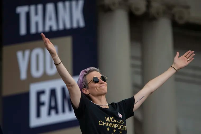 Megan Rapinoe gestures to the crowd outside of New York City Hall at a ceremony following the team's parade down the Canyon of Heroes in lower Manhattan for their World Cup win on Wednesday, July 10, 2019. The team is celebrating their consecutive World Cup win and trip to City Hall, receiving keys for the second time by New York City Mayor Bill de Blasio.