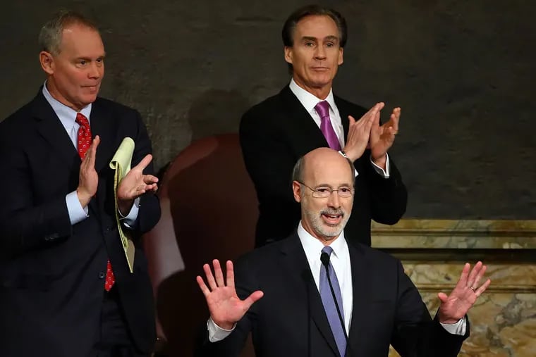 Gov. Wolf (center) delivers his budget address to a joint session of the Pennsylvania House and Senate as House Speaker Mike Turzai (R., Allegheny) and Lt. Gov. Mike Stack (right) listen.