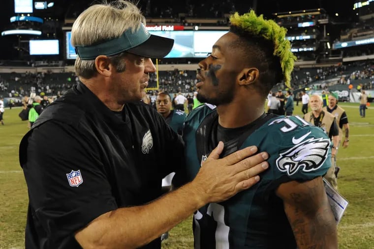 Eagles head coach Doug Pederson talks to rookie cornerback Jalen Mills after the Eagles beat the Steelers 34-3 on Sept. 25, 2016.