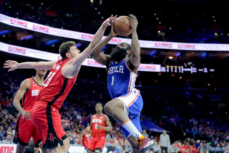 James Harden (right) of the Sixers goes up for a shot against Alperen Sengun of the Rockets during the first half of their game at the Wells Fargo Center on Feb. 13, 2023.