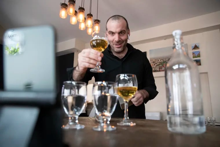 Ara Ishkhanian raises a glass to a customer during one of his virtual dining experiences.