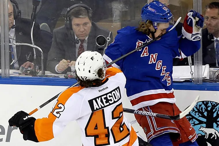 The Flyers' Jason Akeson (42) hits New York Rangers' Carl Hagelin (62) in the face with his stick during the third period in Game 1 of an NHL hockey first-round playoff series on Thursday, April 17, 2014, in New York. Akeson was penalized on the play. The Rangers won the game 4-1. (Frank Franklin II/AP)
