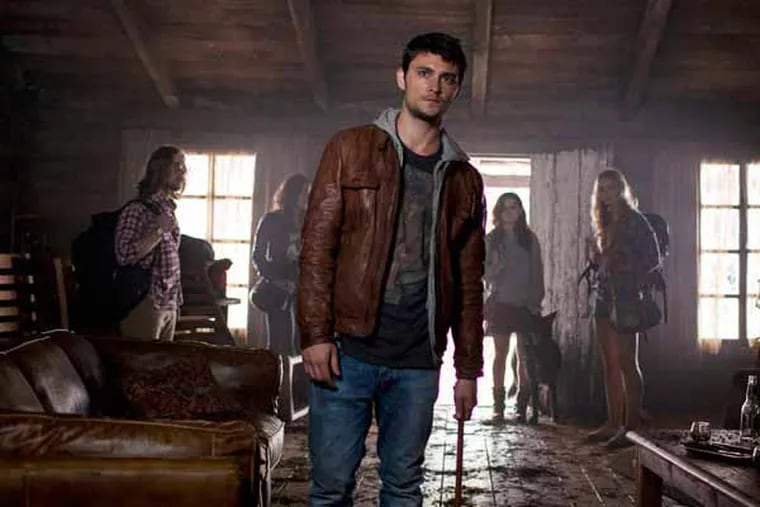This film image released by Sony-TriStar Pictures shows Shiloh Fernandez, center, in a scene from "Evil Dead." (AP Photo/  Sony-TriStar Pictures, Kirsty Griffin)