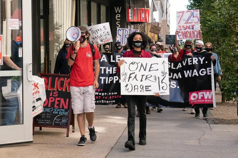 Restaurant workers in Philadelphia demonstrate on Chestnut Street near 13th Street, demanding a $15 minimum wage for all workers in September 2020.