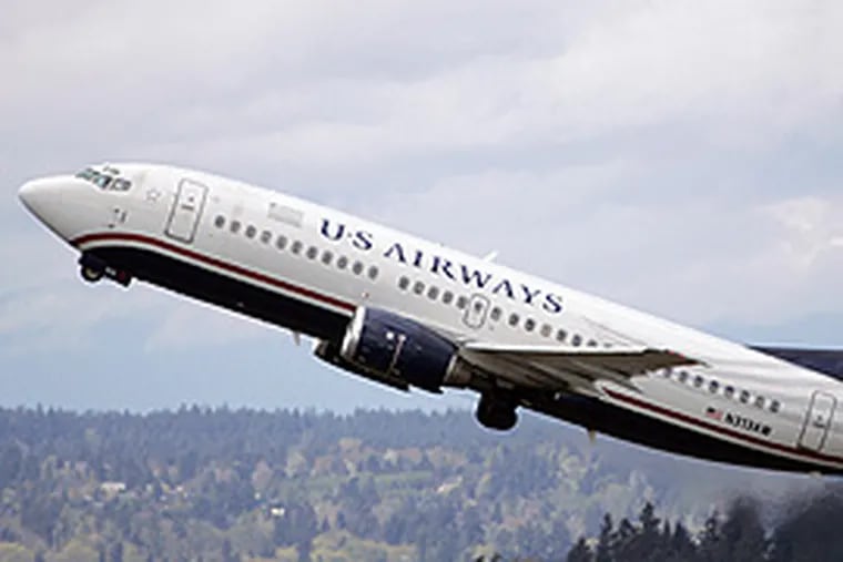 US Airways and United Airlines are said to be talking a merger. An announcement is expected within two weeks. (Elaine Thompson / AP)