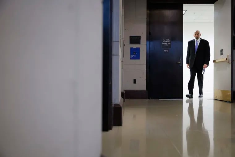 Sen. John Fetterman (D., Pa.) emerges from a closed-door, classified briefing for senators at the U.S. Capitol on Feb. 14, the day before he checked himself into a hospital to receive treatment for clinical depression.