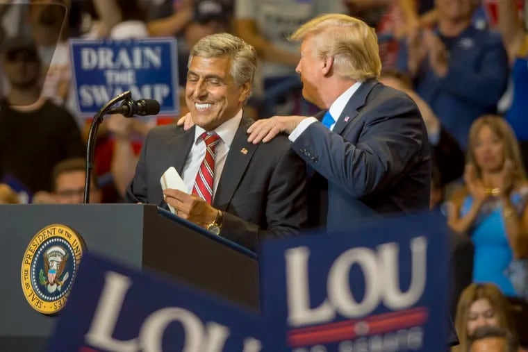 Then-President Trump (right) at a campaign rally for U.S. Rep. Lou Barletta (left) at the Mohegan Sun Arena in Wilkes-Barre in August 2018.