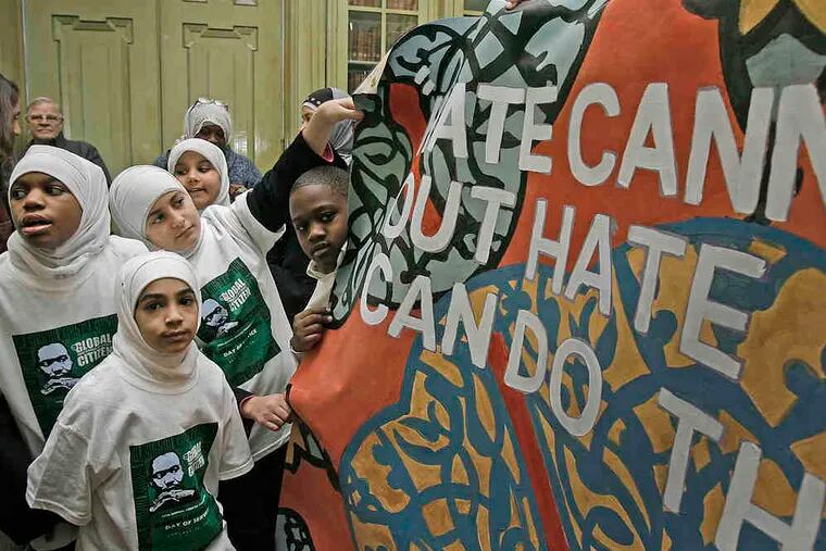 Al-Aqsa Islamic Academy students show off their part of a civil-rights mural.