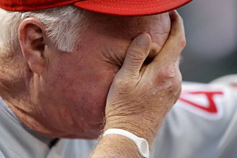 Phillies manager Charlie Manuel can't look during the third inning of the team's loss to the Cardinals. (AP Photo / Jeff Roberson)