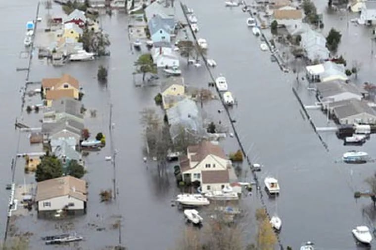 One can't tell the streets from the canals in Waretown on Barnegat Bay across from Long Beach Island on Oct. 30, 2012, a day after Hurricane Sandy crashed ashore. CLEM MURRAY / Staff Photographer