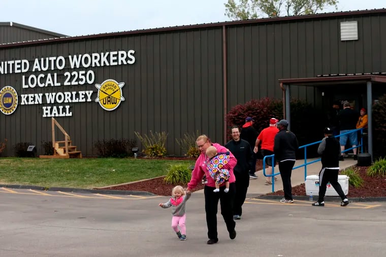 United Auto Worker Lindsey Higgins, exits the the UAW Local 2250 Ken Worley Hall with her two children after voting on the offer made to union workers by General Motors on Thursday, Oct. 24, 2019, in Wentzville, Mo. "I don't feel great about the contract but I have these two to think about. I can't keep striking. I've got to keep a roof over their head," said Higgins. UAW workers have been on strike since Sept. 16.