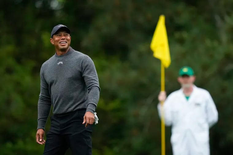 Tiger Woods smiles on on the fifth green during a practice round in preparation for the Masters at Augusta National Golf Club on Tuesday.