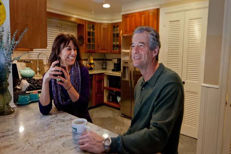 Suzanne and Chuck Cruit relax in their kitchen, where they replaced the countertops with granite.