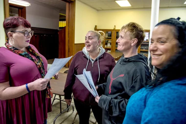 Megan McAllister (left) of Prevention Point talks with participants before a 12-step meeting for people on medication-assisted treatment at St. Mark's Church in Frankford. From left are: Sabrina Schwager, Mary Jane Stein and Michele Donato.
