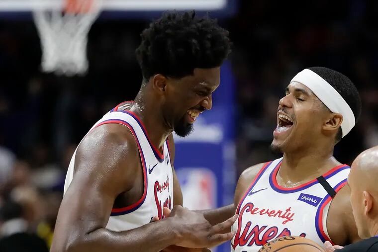 Sixers center Joel Embiid and forward Tobias Harris laugh at the end of the overtime beating the Nets 112-104..