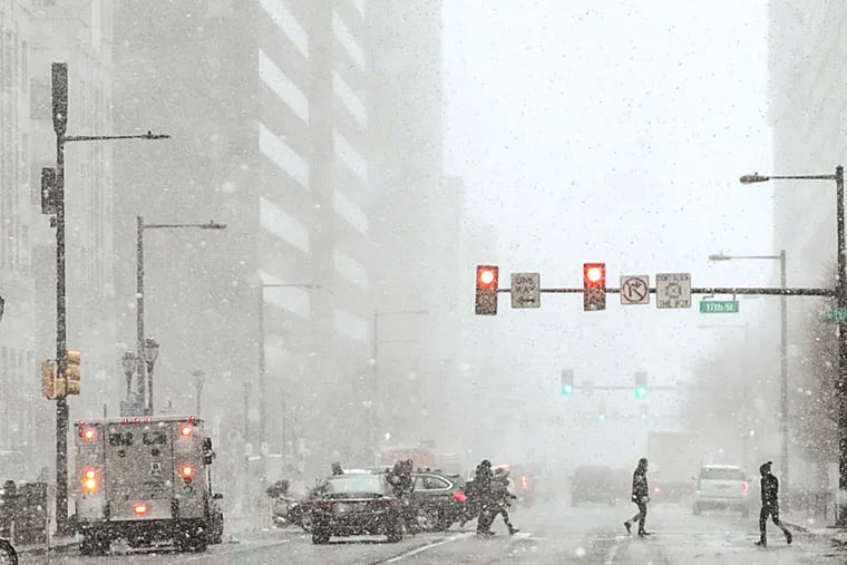 Pedestrians cross at 17th and JFK Blvd in Center City Philadelphia during a snow squall in January; we didn't get much more than the entire winter.